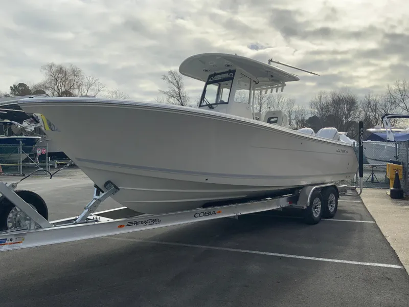 Slide: The Image of 2025 Cobia 285 Open Center Console boat on trailer in parking lot. - 5