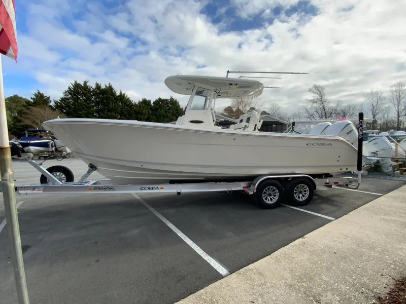 Slide: The Image of 2025 Cobia 285 Open Center Console boat on trailer in parking lot. - 6