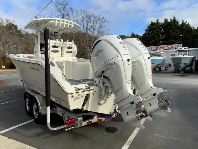 Slide: The Image of 2025 Cobia 285 Open Center Console boat with dual Yamaha engines on trailer. - 9