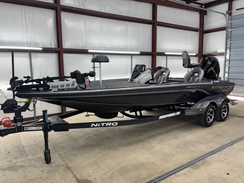 Slide: The Image of 2025 Nitro Z21 XL Pro bass boat in a garage, showcasing sleek design and modern features. - 14