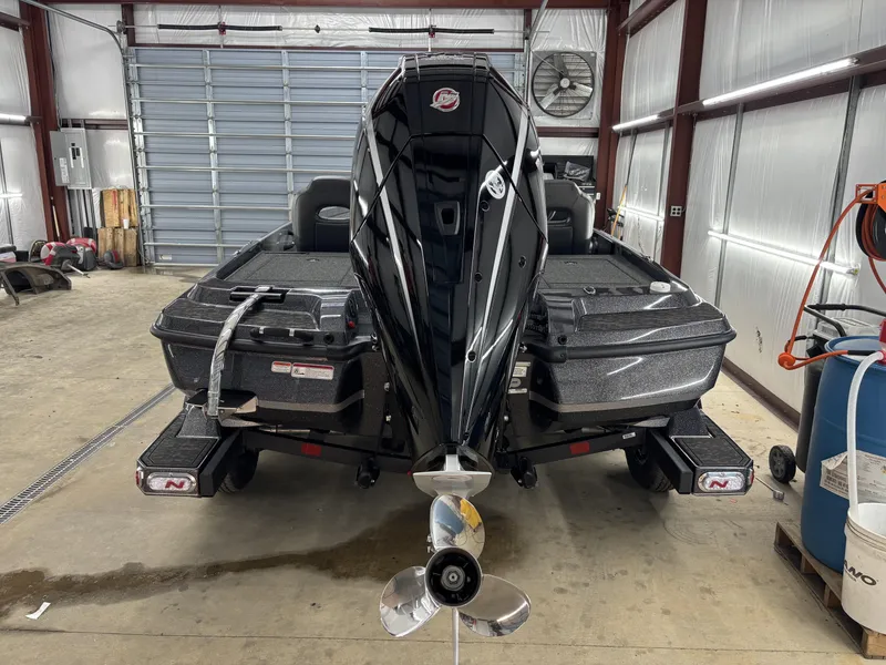 Slide: The Image of 2025 Nitro Z21 XL Pro boat in a garage, rear view with motor and propeller. - 17