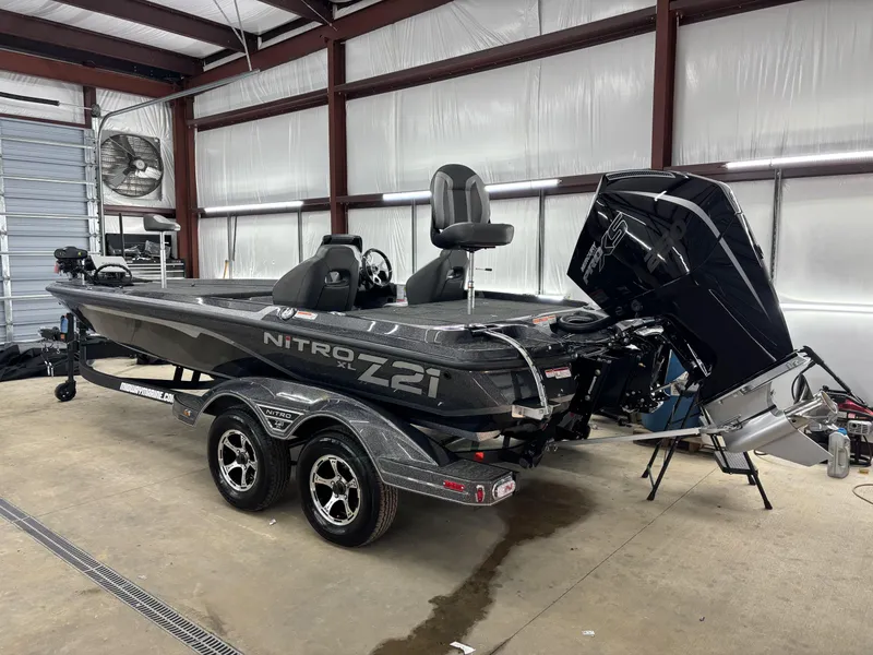 Slide: The Image of 2025 Nitro Z21 XL Pro boat in a garage, showcasing sleek design and powerful engine. - 3