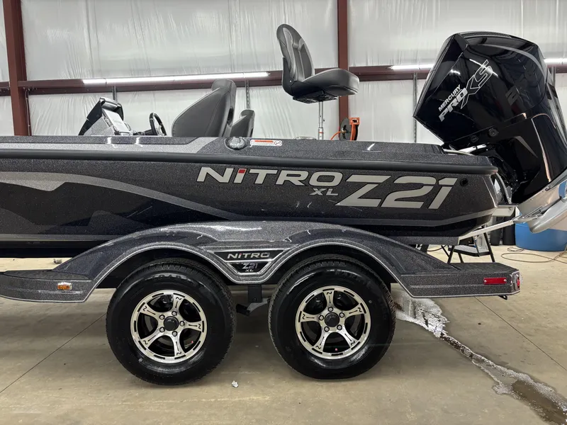 Slide: The Image of 2025 Nitro Z21 XL Pro boat with dual-axle trailer in a garage setting. - 4