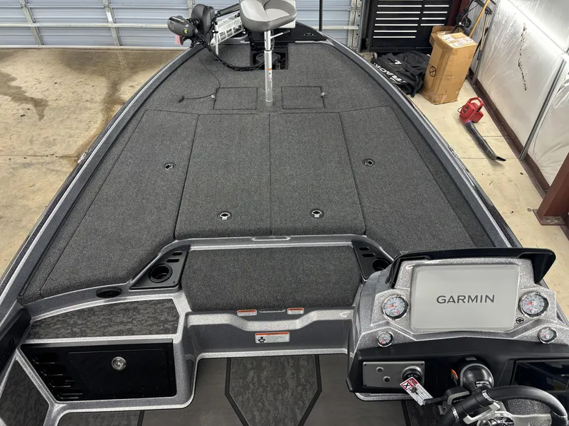Slide: The Image of 2025 Nitro Z21 XL Pro boat interior with Garmin navigation system in a garage setting. - 8