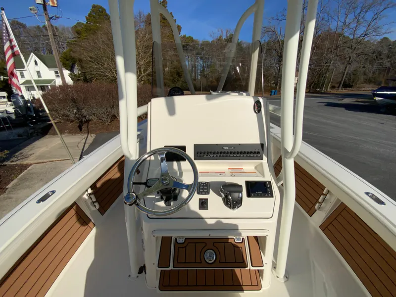 Slide: The Image of 2025 Pathfinder 2400 TRS boat console with steering wheel and controls. - 12