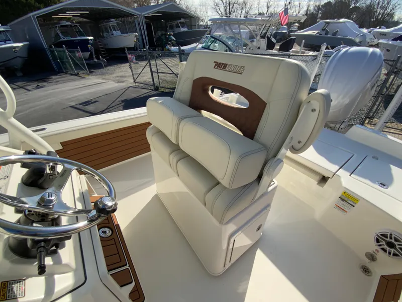 Slide: The Image of 2025 Pathfinder 2400 TRS boat interior with cushioned helm seat and steering wheel. - 14