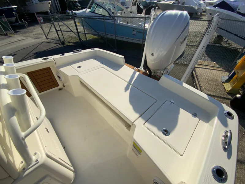Slide: The Image of 2025 Pathfinder 2400 TRS boat interior with seating and outboard motor. - 16