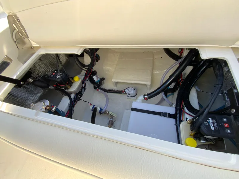 Slide: The Image of 2025 Pathfinder 2400 TRS boat interior wiring and storage compartment. - 19