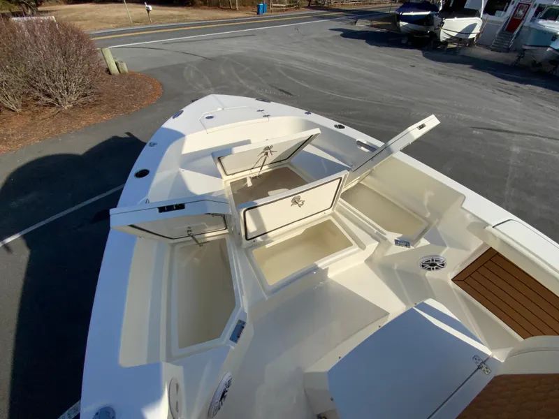Slide: The Image of 2025 Pathfinder 2400 TRS boat with open storage compartments on deck. - 24