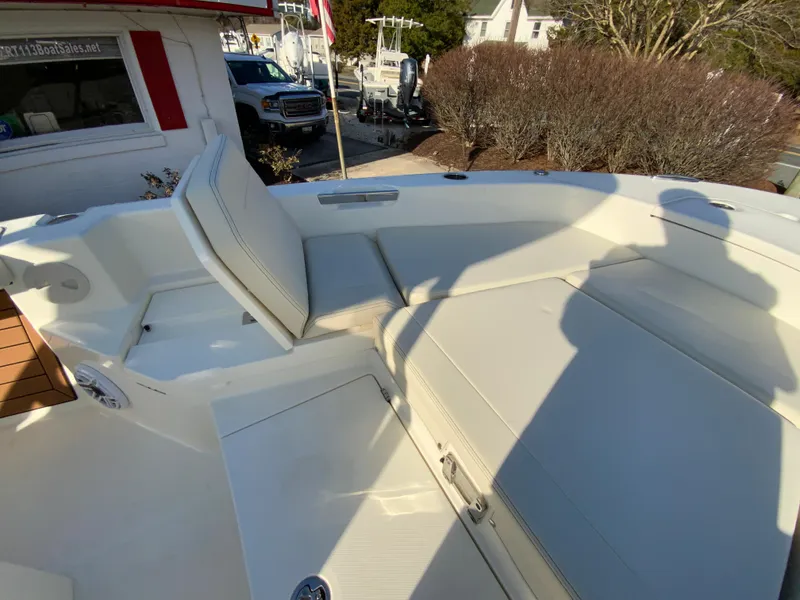 Slide: The Image of 2025 Pathfinder 2400 TRS boat interior with cushioned seating and storage compartments. - 28