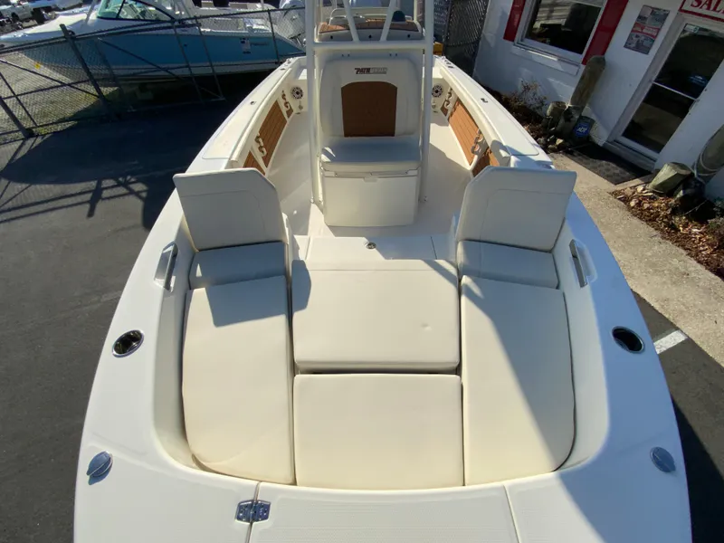 Slide: The Image of 2025 Pathfinder 2400 TRS boat interior with white seating and console. - 29