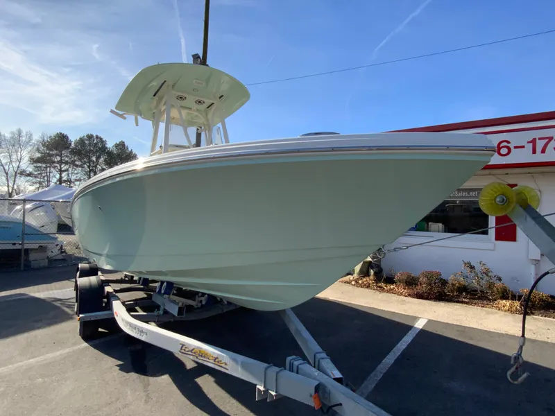 Slide: The Image of 2025 Pathfinder 2400 TRS boat on trailer, parked outdoors. - 3