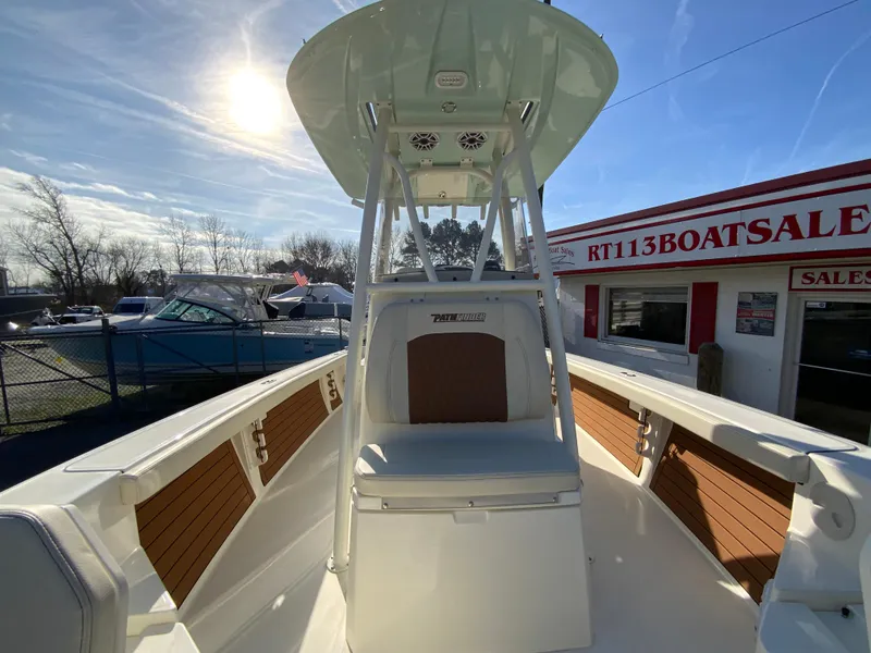 Slide: The Image of 2025 Pathfinder 2400 TRS boat at dealership, sunny day, modern design. - 30