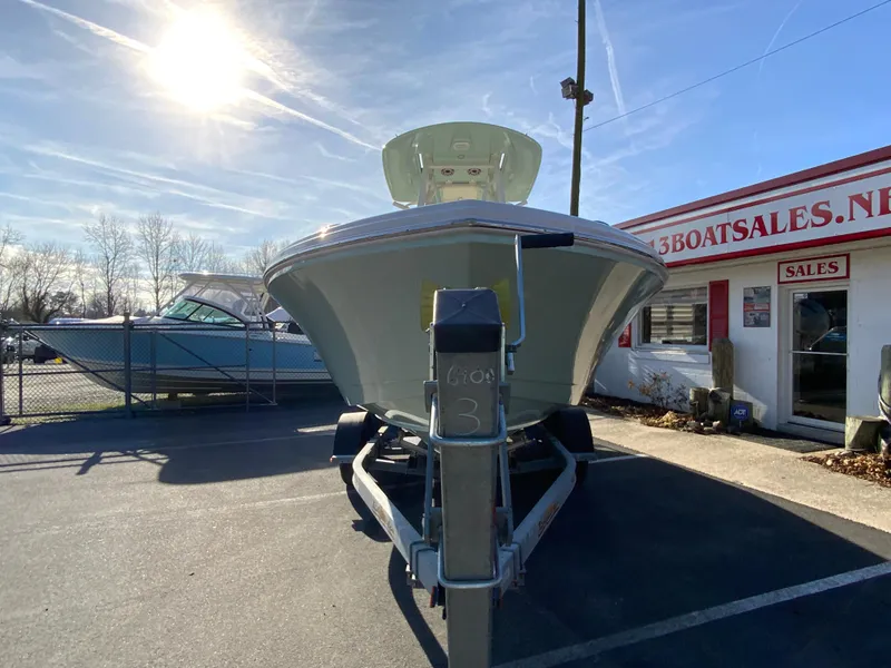 Slide: The Image of 2025 Pathfinder 2400 TRS boat on trailer at dealership under sunny sky. - 4