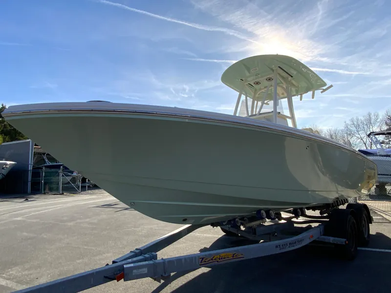 Slide: The Image of 2025 Pathfinder 2400 TRS boat on trailer under clear sky. - 5