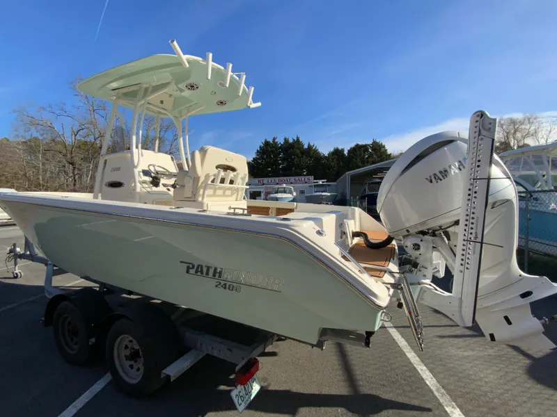 Slide: The Image of 2025 Pathfinder 2400 TRS boat on trailer with Yamaha engine, parked outdoors. - 7
