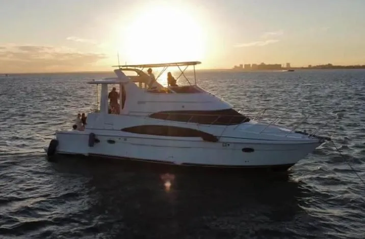 Slide: The Image of 2004 Carver 444 Cockpit Motor Yacht at sunset on open water. - 0