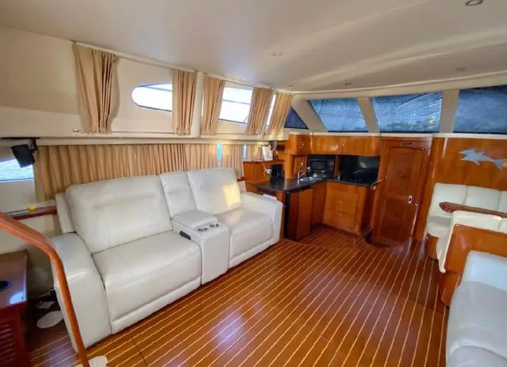 Slide: The Image of Luxurious interior of 2004 Carver 444 Cockpit Motor Yacht with leather seating and wood flooring. - 1