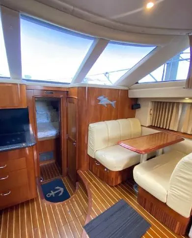 Slide: The Image of Interior of 2004 Carver 444 Cockpit Motor Yacht with wood finish and seating area. - 2