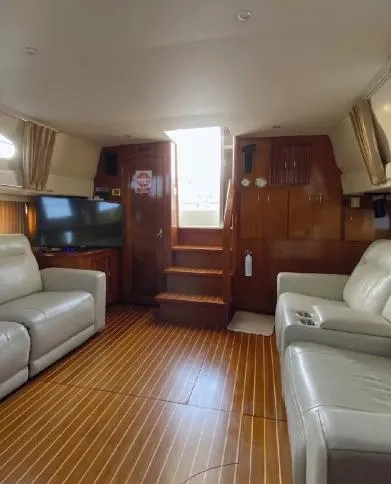 Slide: The Image of Interior of 2004 Carver 444 Cockpit Motor Yacht with leather seating and wooden flooring. - 4