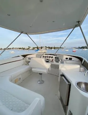 Slide: The Image of 2004 Carver 444 Cockpit Motor Yacht interior with helm, seating, and ocean view. - 5