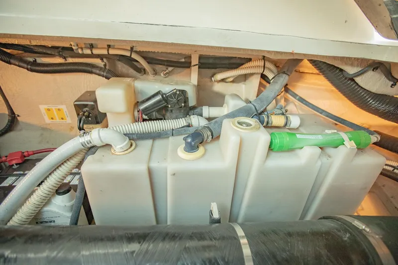 Slide: The Image of Engine compartment of 2005 Sea Ray 420 Sundancer with hoses and components. - 31