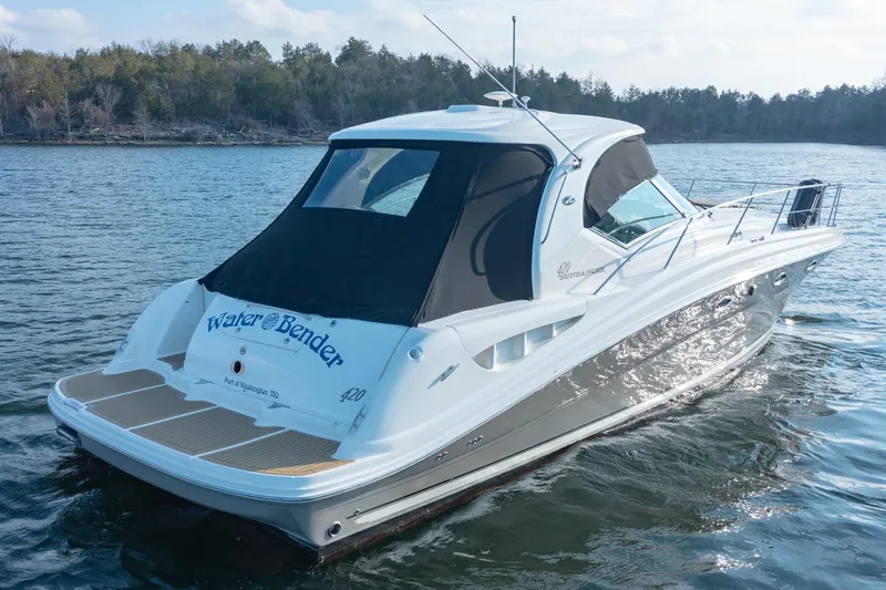 Slide: The Image of 2005 Sea Ray 420 Sundancer yacht cruising on a serene lake. - 5