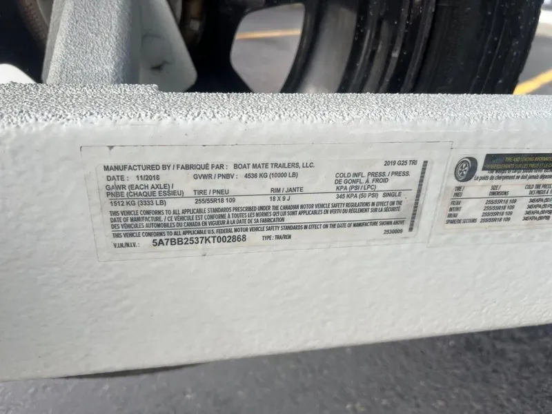 Slide: The Image of Label on a 2019 Nautique G25 trailer, detailing specifications and compliance information. - 28
