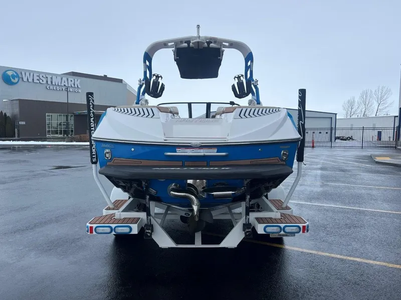 Slide: The Image of 2019 Nautique G25 boat parked outside Westmark Credit Union on a rainy day. - 5