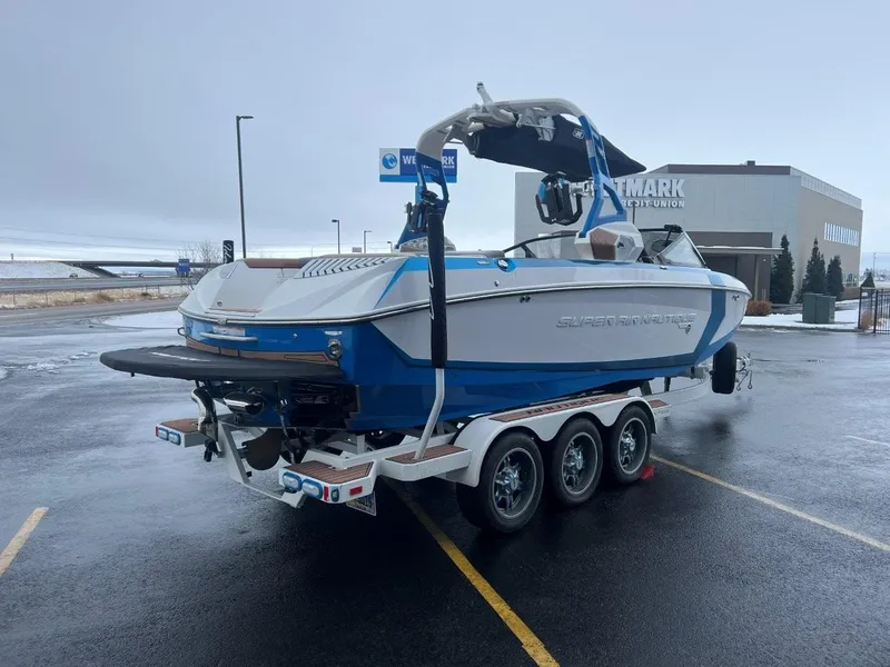 Slide: The Image of 2019 Nautique G25 boat on trailer in parking lot, overcast sky. - 7