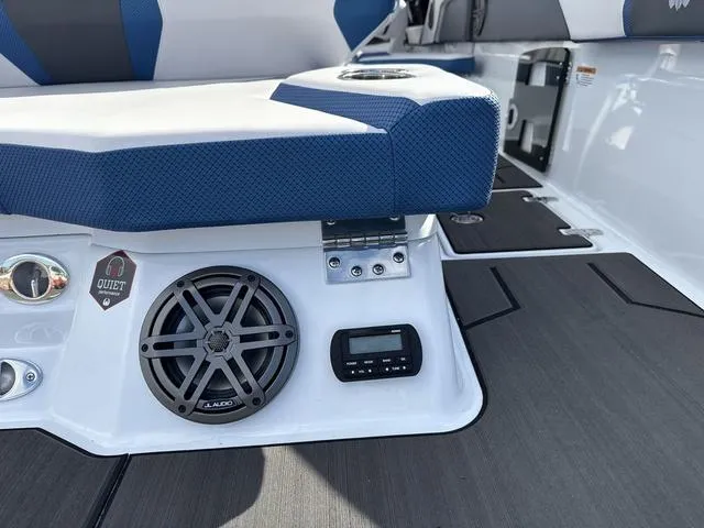 Slide: The Image of 2024 Scarab SBI285 boat interior with speaker, control panel, and cushioned seating. - 11
