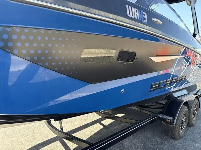 Slide: The Image of 2024 Scarab SBI285 boat, blue and black design, on a trailer. - 18
