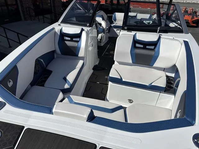 Slide: The Image of 2024 Scarab SBI285 boat interior with white and blue seating, modern design. - 19