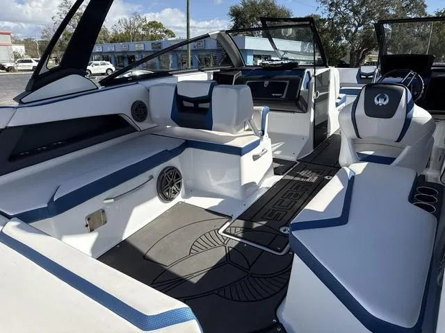 Slide: The Image of 2024 Scarab SBI285 boat interior with blue and white seating, modern design, and spacious layout. - 21