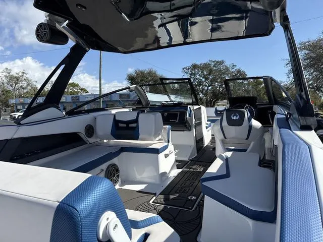 Slide: The Image of 2024 Scarab SBI285 boat interior with blue and white seating, sleek design, and modern features. - 9