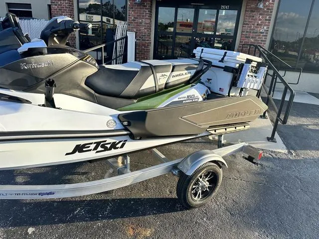 Slide: The Image of 2025 Kawasaki Jet Ski Ultra 160 on trailer, parked outside a building. - 5