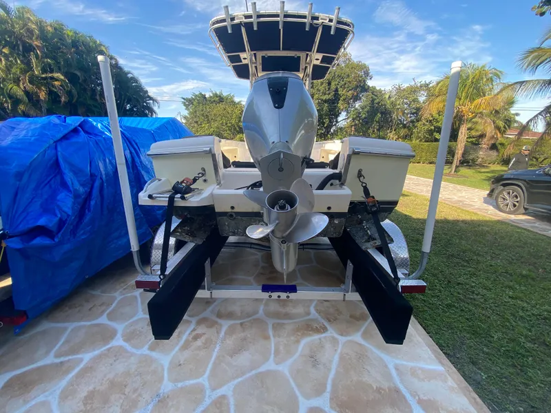 Slide: The Image of 2005 Scout 210 Sportfish boat on trailer, rear view, with outboard motor. - 13
