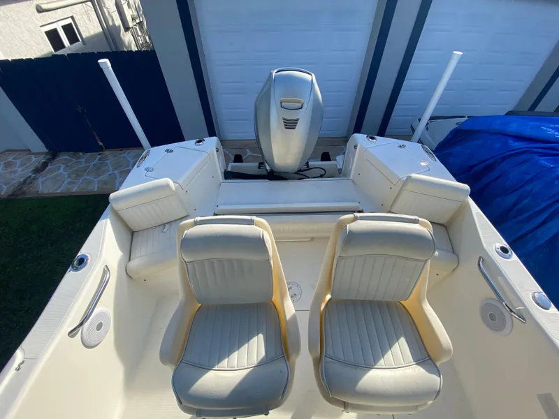 Slide: The Image of 2005 Scout 210 Sportfish boat with dual seats and outboard motor. - 16