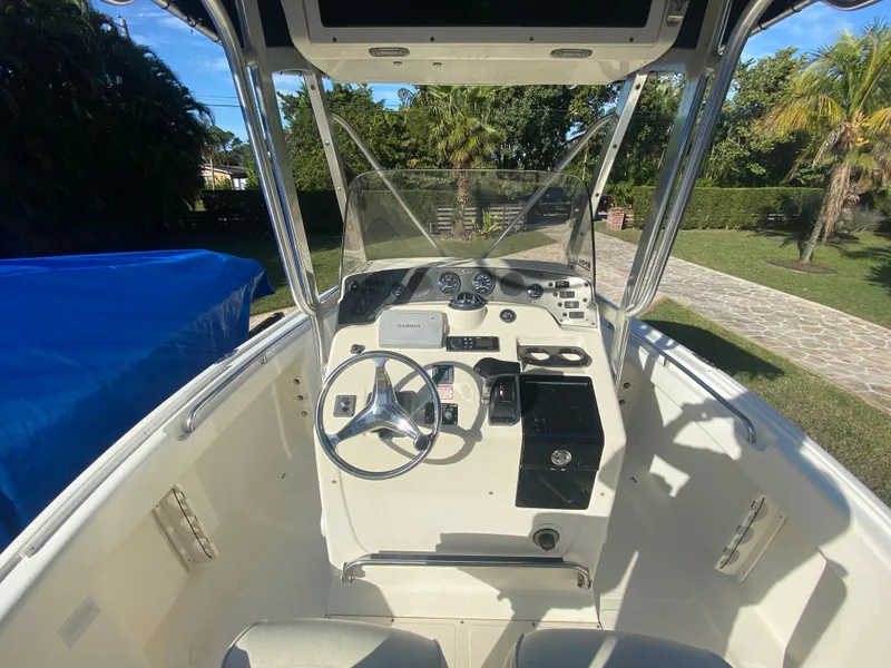 Slide: The Image of 2005 Scout 210 Sportfish boat cockpit with steering wheel and controls. - 20