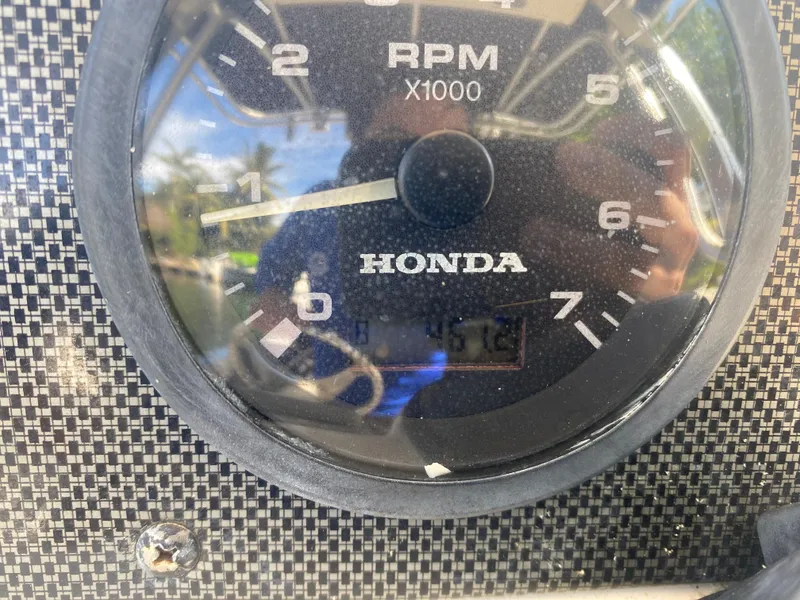 Slide: The Image of Close-up of Honda RPM gauge on 2005 Scout 210 Sportfish boat. - 23