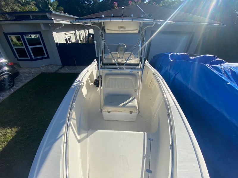 Slide: The Image of 2005 Scout 210 Sportfish boat with center console in a residential driveway. - 27