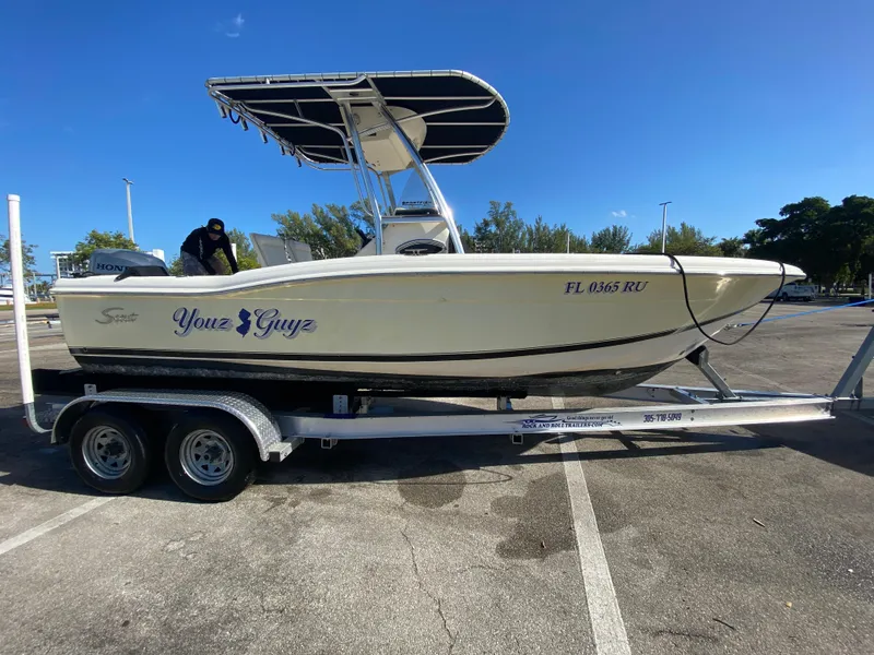 Slide: The Image of 2005 Scout 210 Sportfish boat on trailer in parking lot. - 3