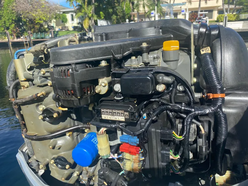 Slide: The Image of Close-up of a 2005 Scout 210 Sportfish boat engine by the water. - 30