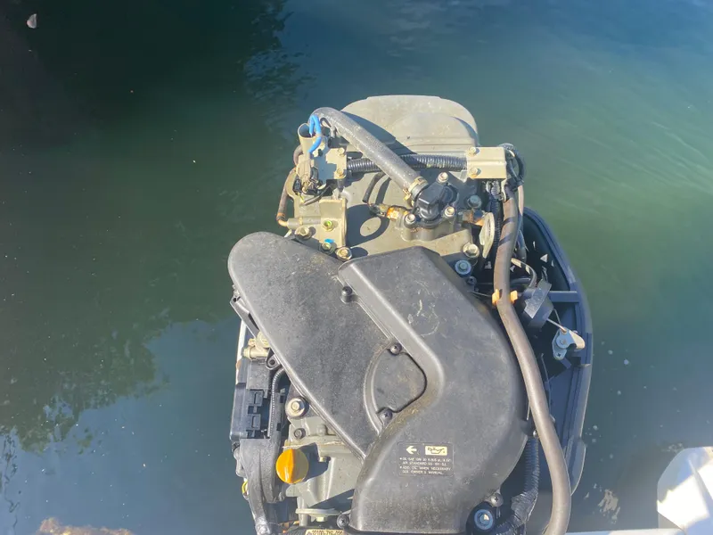 Slide: The Image of 2005 Scout 210 Sportfish boat engine in water, top view. - 32