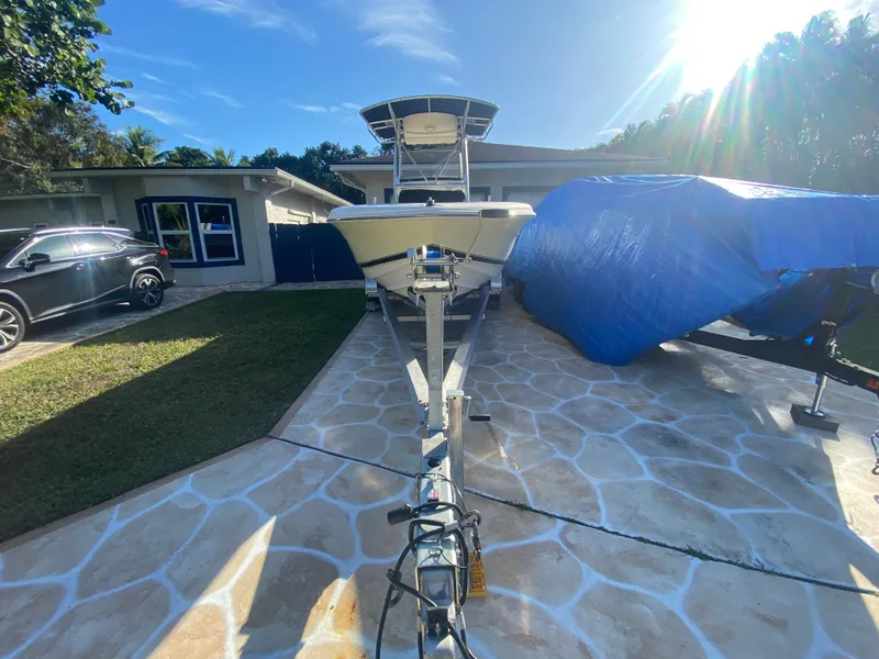 Slide: The Image of 2005 Scout 210 Sportfish boat on trailer in sunny driveway. - 8