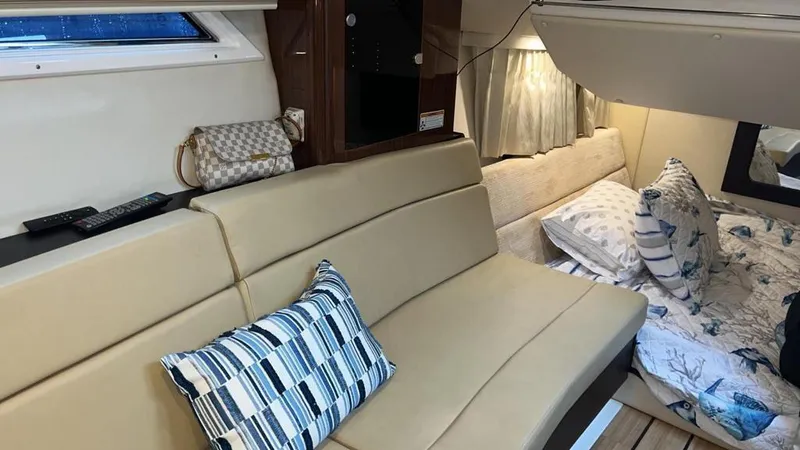 Slide: The Image of Interior of 2015 Regal 35 Sport Coupe with beige seating and patterned pillows. - 16