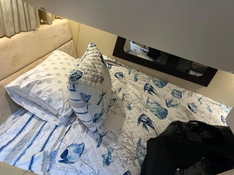 Slide: The Image of Cozy cabin interior of 2015 Regal 35 Sport Coupe with nautical-themed bedding. - 17