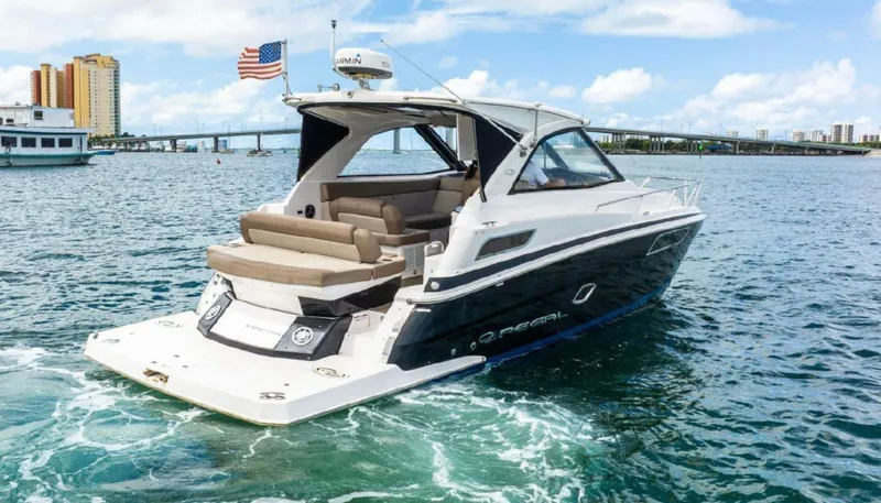 Slide: The Image of 2015 Regal 35 Sport Coupe boat cruising on a sunny day. - 2