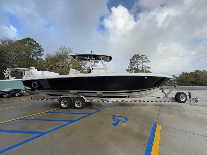 Slide: The Image of 2018 Fountain 34 CC boat on trailer in parking lot. - 11