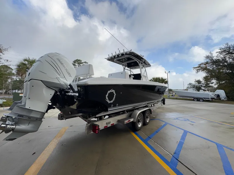 Slide: The Image of 2018 Fountain 34 CC boat on trailer with dual outboard engines. - 14